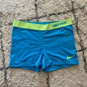 Blue & lime green/yellow Nike Pro compression shorts.